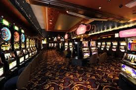Live dealer conducting a Spadegaming Baccarat round with cards dealt and betting results displayed